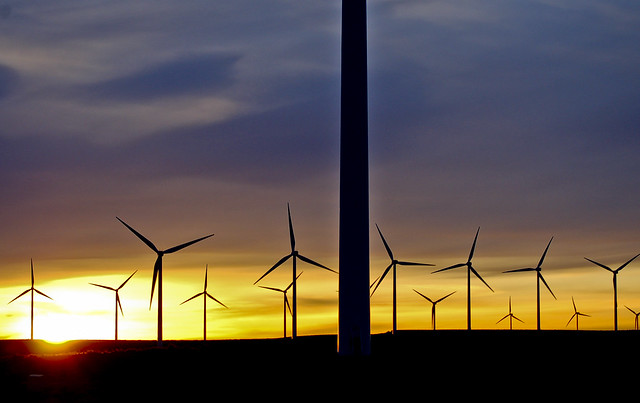 The sun sets behind several wind turbines at Wild Horse Wind and Solar Facility.